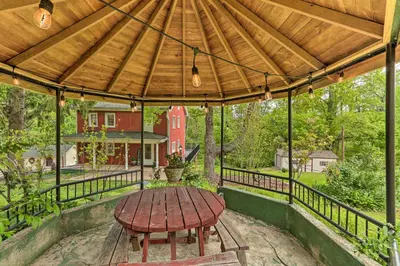 a wooden table on a patio with a wooden roof at The Millersburg Mountain House Getaway with Gazebo! in Millersburg