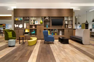 a lobby with chairs and a tv and a couch at Home2 Suites by Hilton Philadelphia Convention Center in Philadelphia
