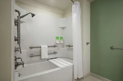 a bathroom with a tub and a shower with towels at Home2 Suites by Hilton Philadelphia Convention Center in Philadelphia