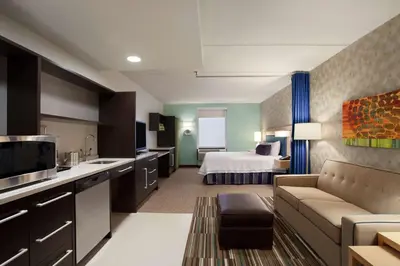 a hotel room with a bed and a living room at Home2 Suites by Hilton Philadelphia Convention Center in Philadelphia