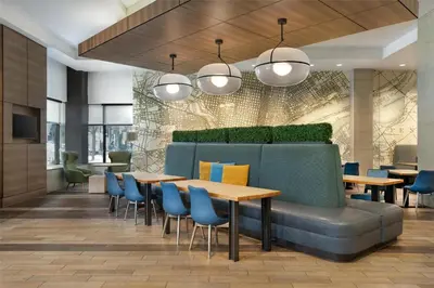 a restaurant with blue chairs and tables and lights at Home2 Suites by Hilton Philadelphia Convention Center in Philadelphia