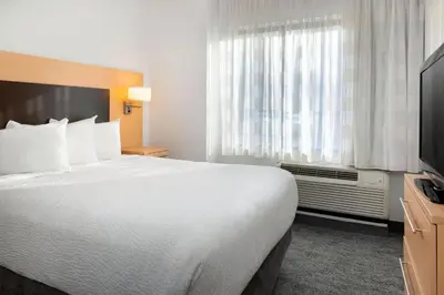 a hotel room with a large bed and a window at TownePlace Suites by Marriott York in York