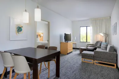 a living room with a dining room table and a couch at TownePlace Suites by Marriott York in York