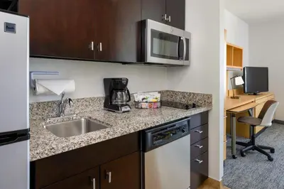 a small kitchen with a sink and a microwave at TownePlace Suites by Marriott York in York