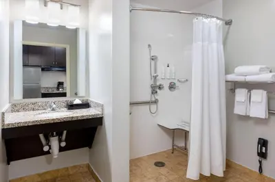 a bathroom with a shower and a sink and a shower curtain at TownePlace Suites by Marriott York in York