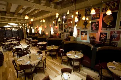 a dining room with tables and chairs and lights at Mohegan Pennsylvania Casino Resort - Adults Only in Wilkes-Barre