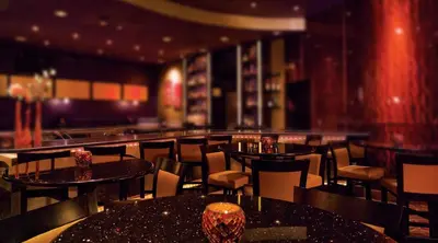 a restaurant with tables and chairs and a bar at Mohegan Pennsylvania Casino Resort - Adults Only in Wilkes-Barre