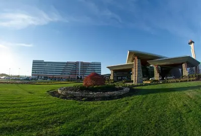 a building in a field with a building in the background at Mohegan Pennsylvania Casino Resort - Adults Only in Wilkes-Barre