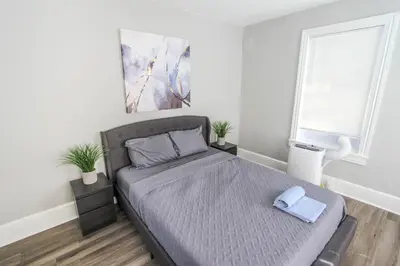 a bedroom with a bed with a blue pillow on it at ☆☆ Modern Coed Dorm in Reading ☆☆ in Reading