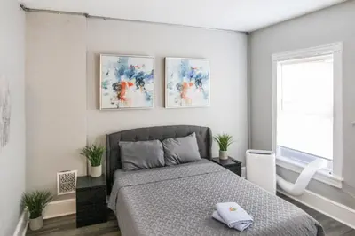 a bedroom with a bed and three paintings on the wall at ☆☆ Modern Coed Dorm in Reading ☆☆ in Reading