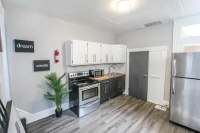 a kitchen with white cabinets and a stainless steel refrigerator at ☆☆ Modern Coed Dorm in Reading ☆☆ in Reading
