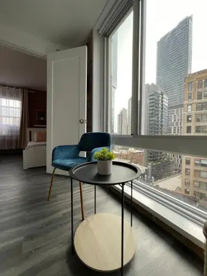 a room with a table and a chair and a large window at Hotel and the City, Empire State Building in New York