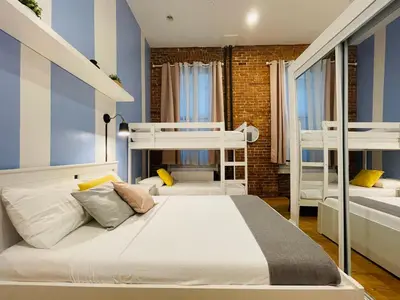 a bedroom with two bunk beds and a brick wall at Hotel and the City, Empire State Building in New York