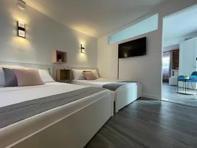 a bedroom with two beds and a tv on the wall at Hotel and the City, Empire State Building in New York