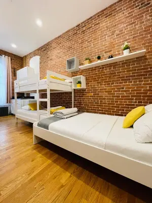 two beds in a room with a brick wall at Hotel and the City, Empire State Building in New York