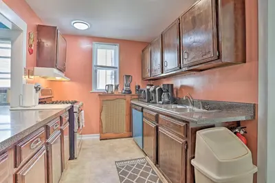 a kitchen with wooden cabinets and a sink at Suburban Home with Backyard Patio Less Than 7 Miles to Dtwn! in Lansdowne