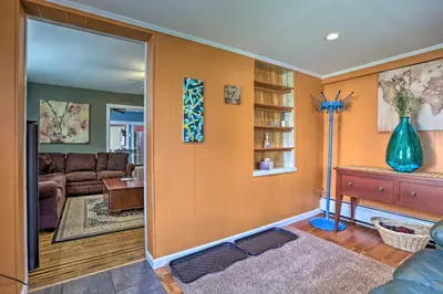 a living room with a couch and a table at Suburban Home with Backyard Patio Less Than 7 Miles to Dtwn! in Lansdowne