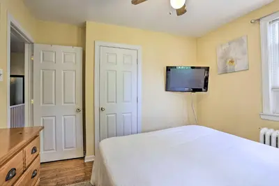 a bedroom with a bed and a tv on the wall at Suburban Home with Backyard Patio Less Than 7 Miles to Dtwn! in Lansdowne