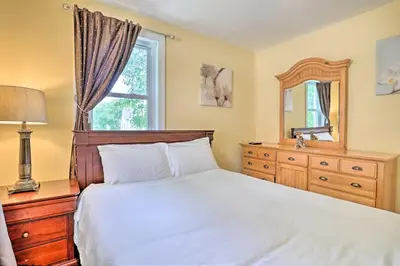 a bedroom with a bed and a dresser and a mirror at Suburban Home with Backyard Patio Less Than 7 Miles to Dtwn! in Lansdowne