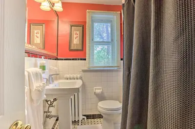 a bathroom with a white toilet and a sink at Suburban Home with Backyard Patio Less Than 7 Miles to Dtwn! in Lansdowne