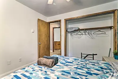 a bedroom with a bed and a large window at PoolandBeach Access Spacious Tobyhanna Family Home! in Tobyhanna