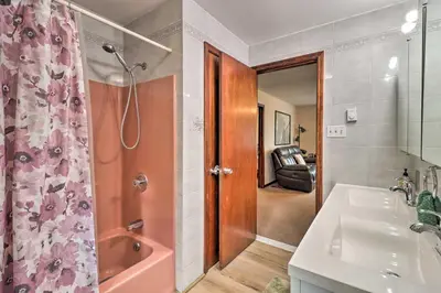a bathroom with a shower and a sink and a tub at PoolandBeach Access Spacious Tobyhanna Family Home! in Tobyhanna