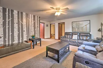 a living room with leather furniture and a ceiling fan at PoolandBeach Access Spacious Tobyhanna Family Home! in Tobyhanna
