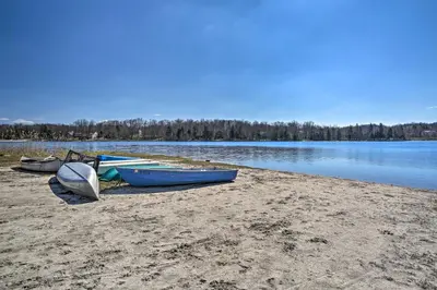 a group of boats sitting on the shore of a lake at PoolandBeach Access Spacious Tobyhanna Family Home! in Tobyhanna
