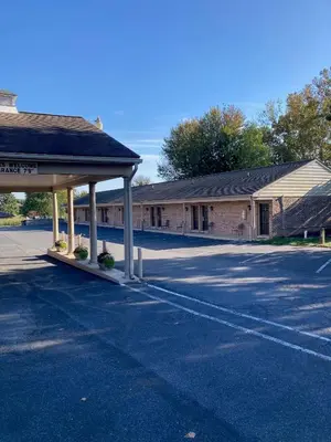 an empty parking lot in front of a building at Country Squire Inn and Suites in New Holland