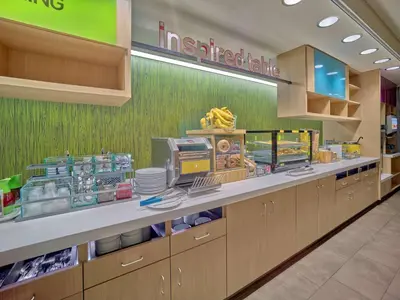 a fast food restaurant with a counter with food at Home2 Suites By Hilton Wayne, NJ in Wayne