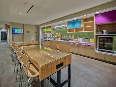 a restaurant with a long table and chairs in it at Home2 Suites By Hilton Wayne, NJ in Wayne