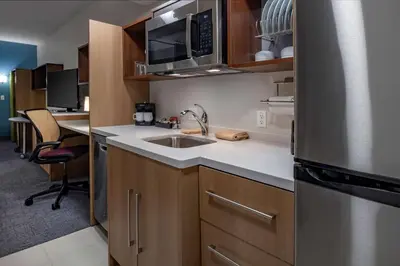 a small kitchen with a sink and a refrigerator at Home2 Suites By Hilton Wayne, NJ in Wayne