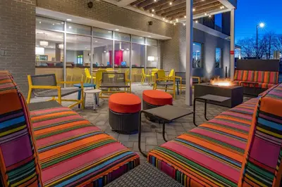 a patio with colorful chairs and tables in a restaurant at Home2 Suites By Hilton Wayne, NJ in Wayne