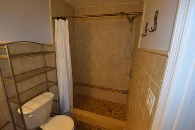 a bathroom with a toilet and a shower at Riverhouse Extended Stay Apartment in Jersey City