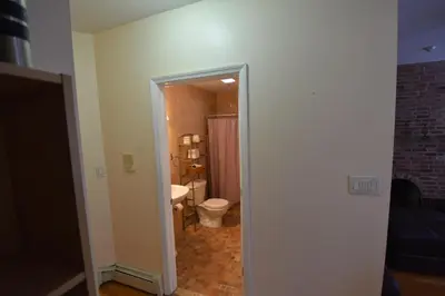 a bathroom with a toilet and a sink at Riverhouse Extended Stay Apartment in Jersey City