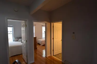 a room with two doors and a bedroom with a bed at Riverhouse Extended Stay Apartment in Jersey City