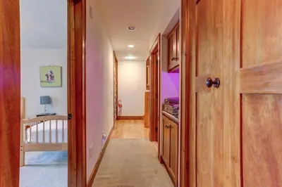 a hallway leading to a bedroom with a door at Peaceful Mountian Oasis Firepit, Hot Tub, Sauna! in Vernon Township