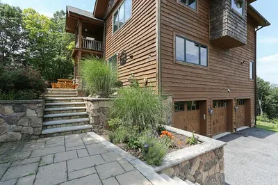 a house with a stone walkway in front of it at Peaceful Mountian Oasis Firepit, Hot Tub, Sauna! in Vernon Township