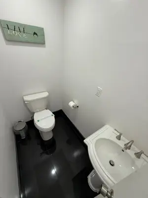 a white bathroom with a toilet and a sink at 31 Street Broadway Hotel in New York