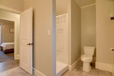 a bathroom with a toilet and a walk in shower at Waterfront Home with Hot Tub in Wrightsville! in Wrightsville