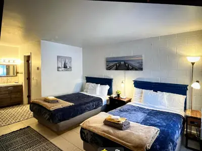 a hotel room with two beds and a bathroom at Rolling Hills Motel in Wantage