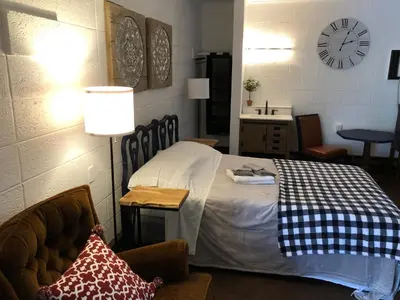 a bedroom with a bed and a clock on the wall at Rolling Hills Motel in Wantage