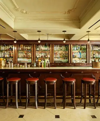 a bar with red stools in a restaurant at The Marlton Hotel in New York
