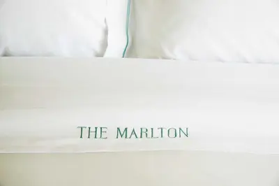 a white bed with the mutation written on it at The Marlton Hotel in New York