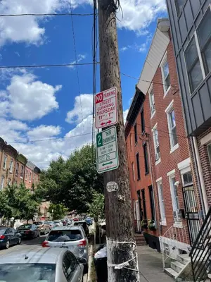 two signs on a telephone pole on a street at Clover 2900 - Apartment and Rooms with Private Bathroom near Washington Ave South Philly in Philadelphia