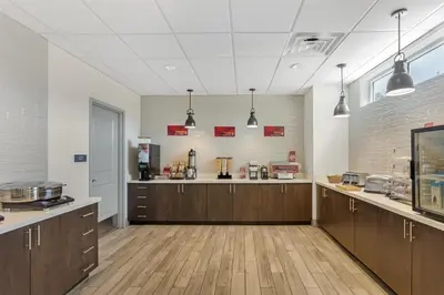 a large kitchen with wooden cabinets in a room at Best Western Plus Hershey in Hershey