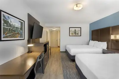 a hotel room with two beds and a flat screen tv at Best Western Plus Hershey in Hershey