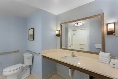 a bathroom with a sink and a toilet and a mirror at Best Western Plus Hershey in Hershey