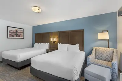 a hotel room with two beds and a chair at Best Western Plus Hershey in Hershey