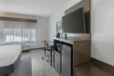 a hotel room with a bed and a flat screen tv at Best Western Plus Hershey in Hershey